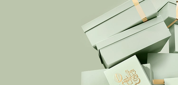 sage green background with sage green Origins gift boxes